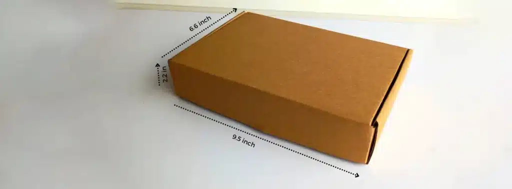 A cardboard box displaying measurements, highlighting its length, width, and depth for comparison