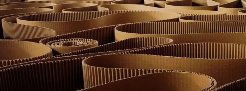 A circular arrangement of corrugated cardboard tubes stacked together, showcasing their texture and structure.