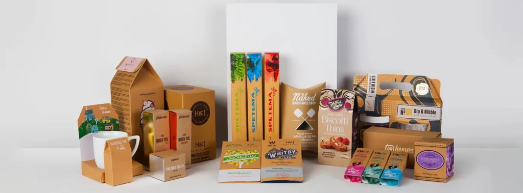 A variety of packaging and products arranged on a white surface, showcasing different designs and materials