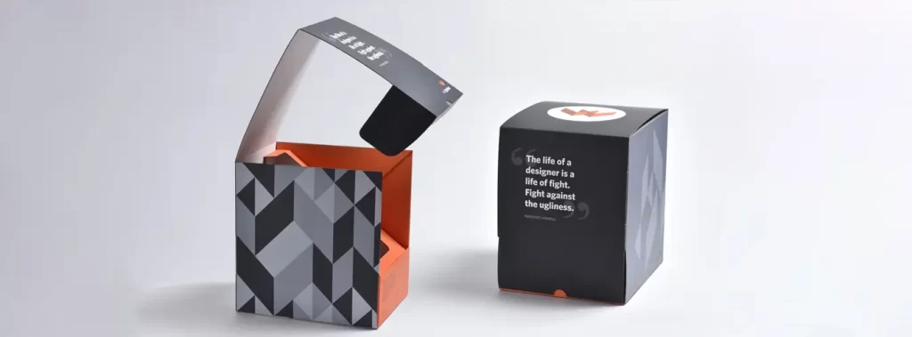 A visually appealing box adorned with a black and orange design, highlighting the smooth finish of soft-touch lamination