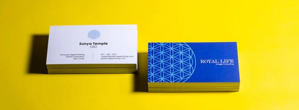 Business cards featuring a blue and yellow design, enhanced with a soft-touch coating for a premium feel